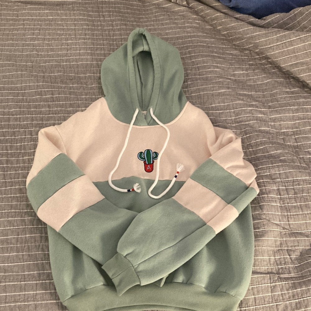 This is a green and cream sweatshirt